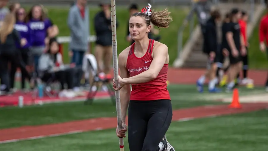 JoJo Huczko running with pole on field