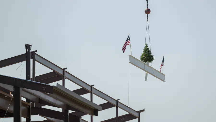 The final beam is hoisted to the top of the Robotics Innovation Center.