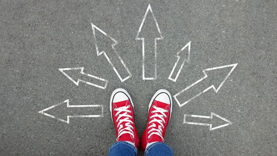 Shoes in a circle of outward-pointing arrows in chalk.