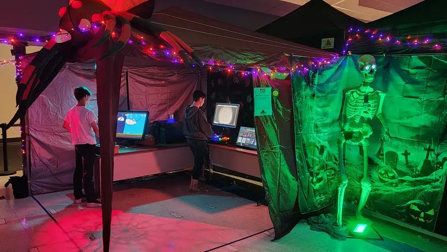 A crew works to build attractions at a Halloween festival.