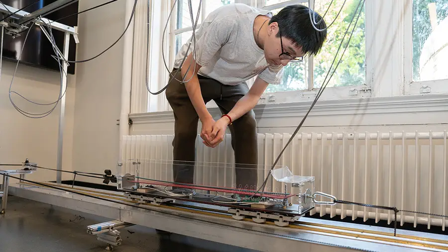 Student examines testbed featuring different bridge materials