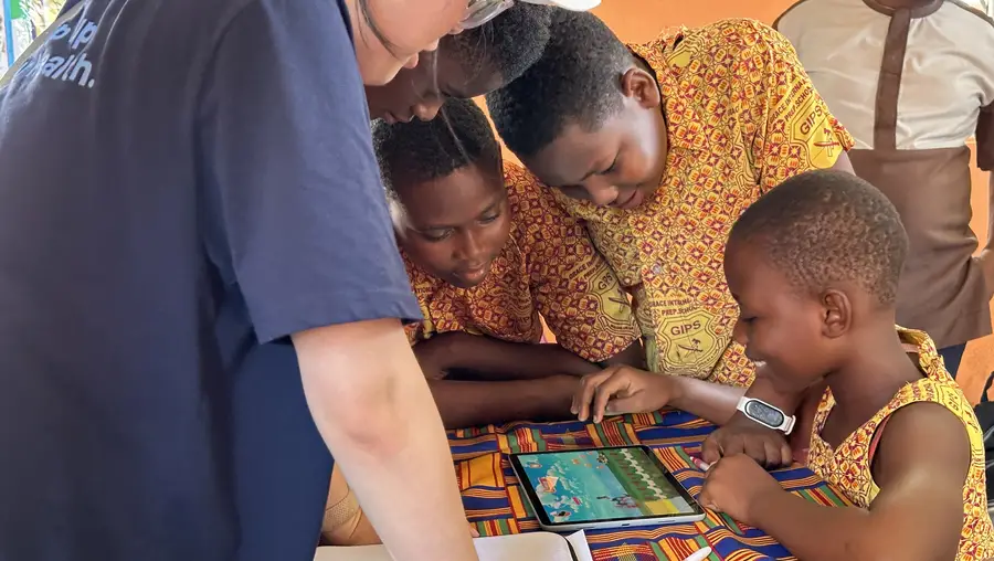 Students in Ghana use a tablet. 