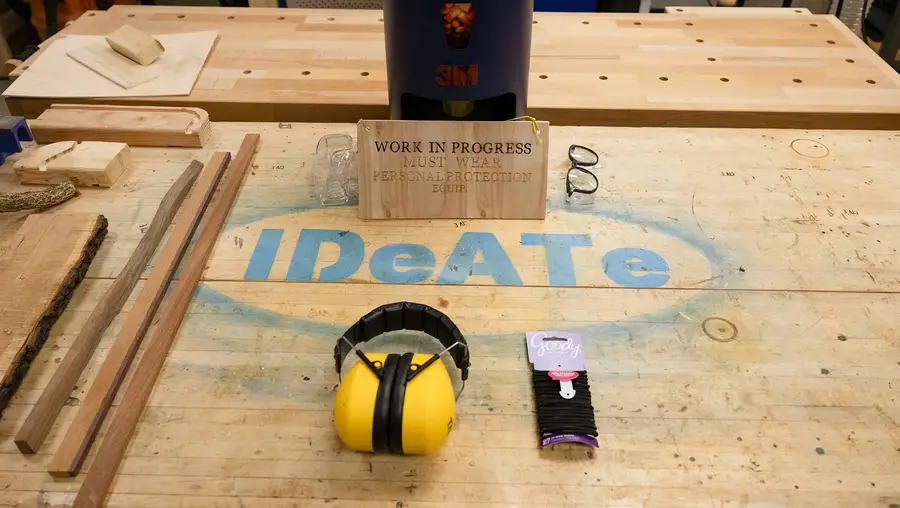 IDeATe painted in blue letters on wood