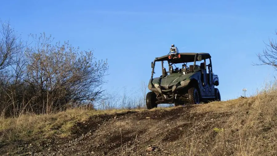 An autonomously-driving ATV at the top of a rocky hill