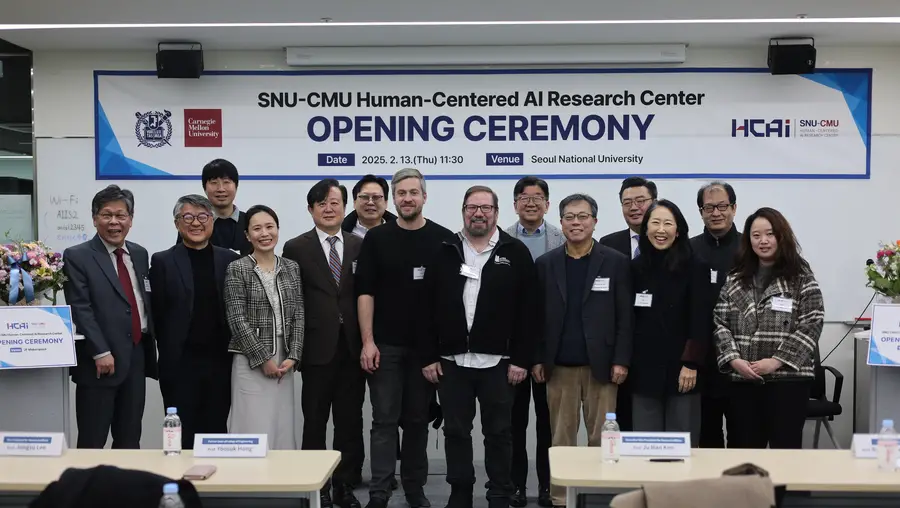 group of 14 SNU and CMU faculty standing in front of a banner that reads Opening Ceremony for the new HCAI center