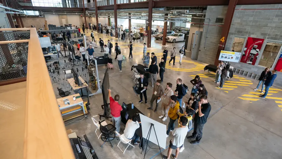 Attendees brows demo booths in the Robotics Innovation Center as part of the 2026 IROS conference..