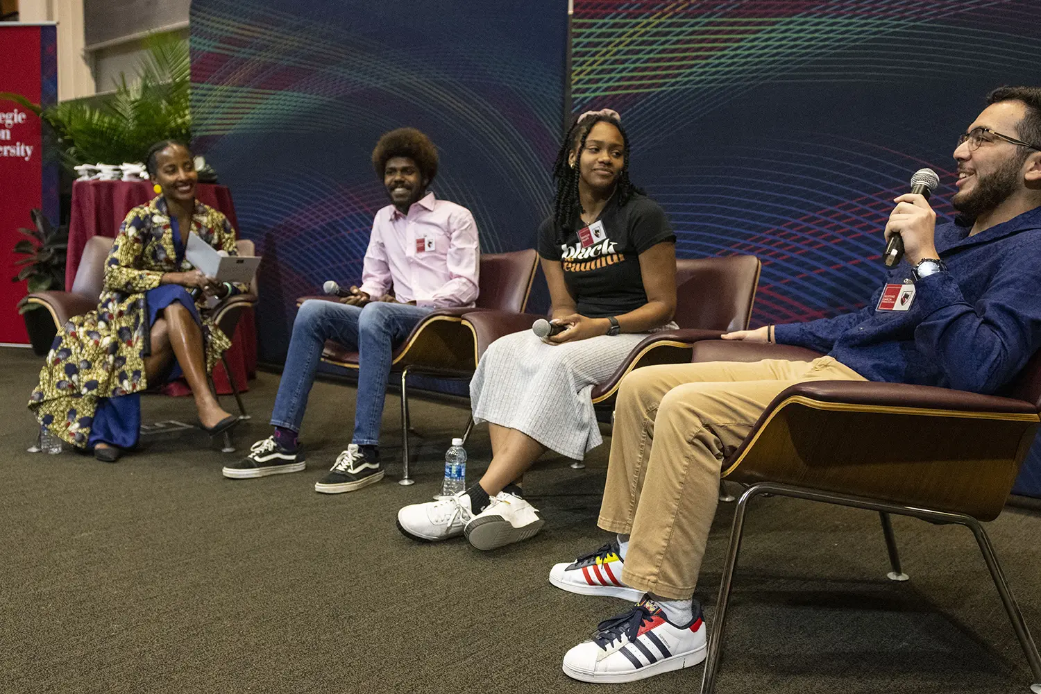 panel discussion showing four people sitting on a stage