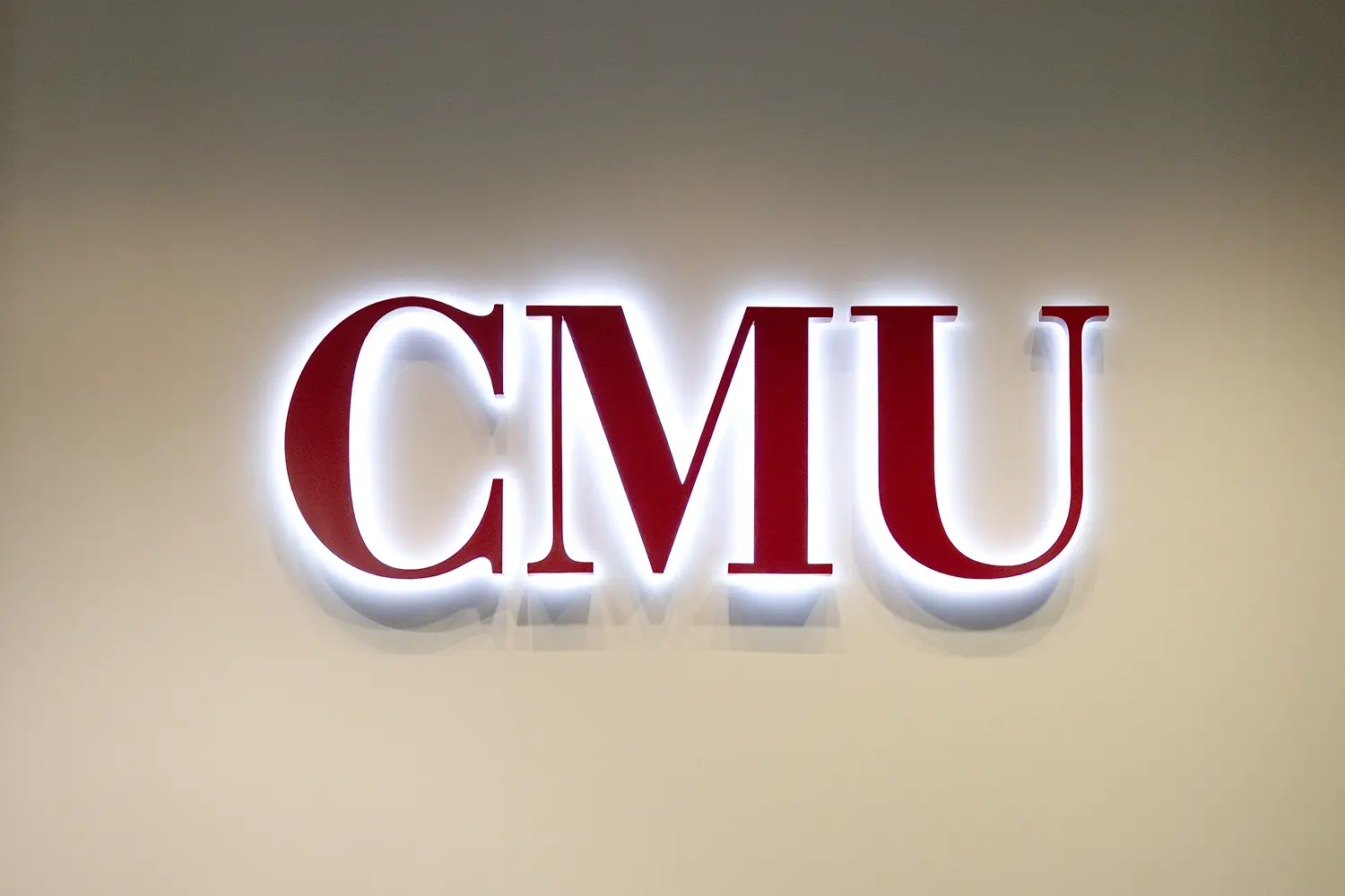 Red CMU letters with light protruding from behind.