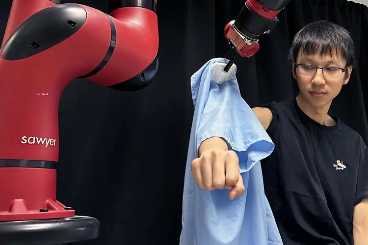 A robot helping a student get dressed.