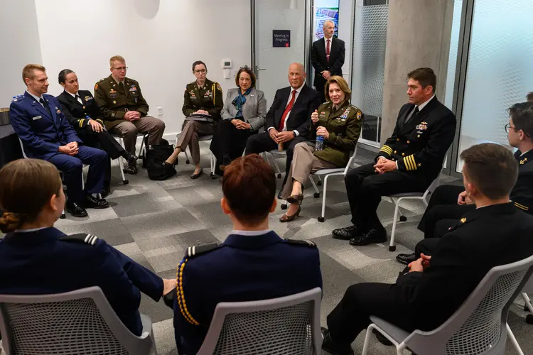 Gen. Richardson and CMU midshipmen seated in a circle having a discussion