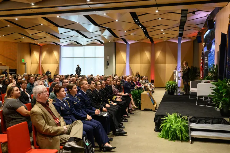 people listening to General Richardson talk on stage