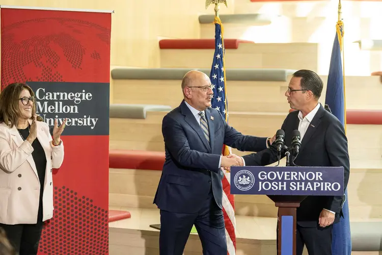 Farnam Jahanian shakes hands with Gov. Josh Shapiro