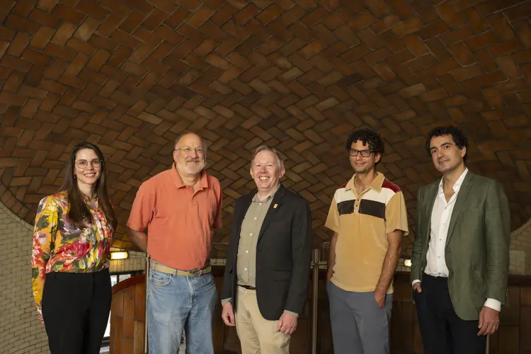 five people standing inside Baker Hall