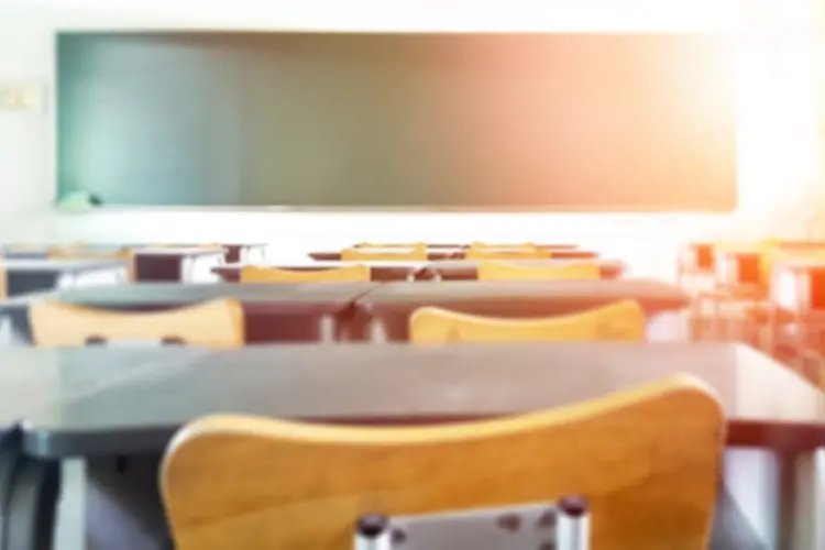 view of front of classroom from behind desks and chairs