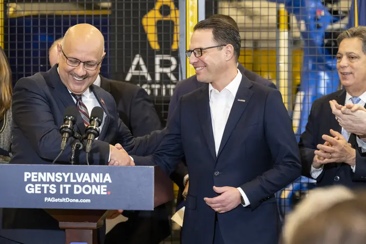 Farnam Jahanian shakes hands with Gov. Josh Shapiro