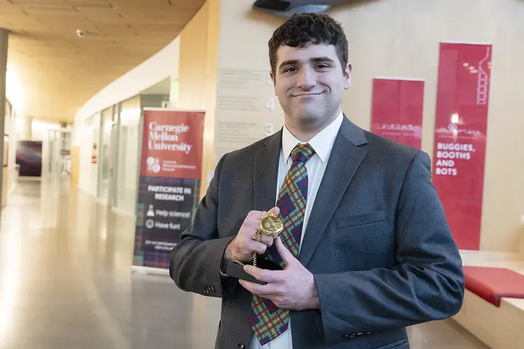 Benjamin Glaser holding award