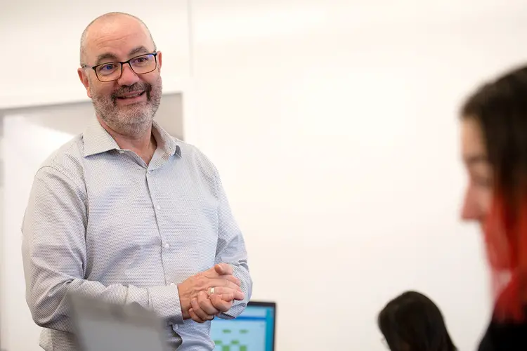 professor standing in classroom across from student