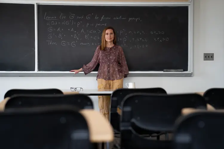 Irina Gheorghiciuc, associate teaching professor in the Department of Mathematical Sciences, stands in front of a chalkboard.