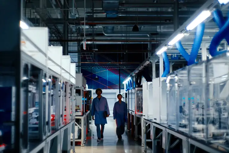 Two people walk through the Bakery Square lab.