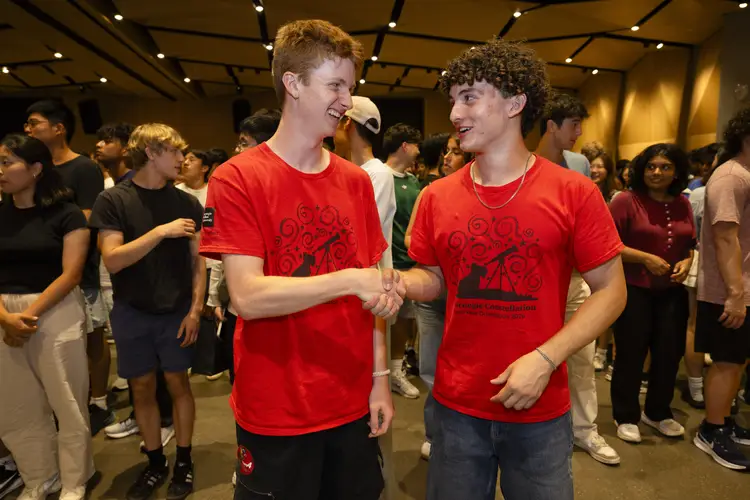 Students shake hands during the day's icebreaking and friend-making events.