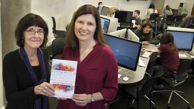 Authors holding book