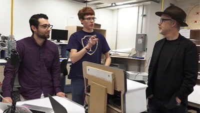 Image of Adam Savage talking with students