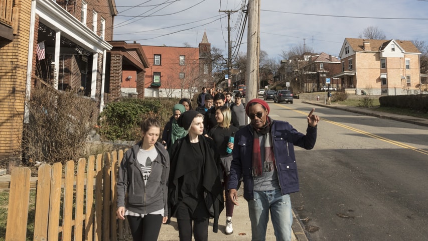 Image of students and Rev. Tim Smith walk through Hazelwood