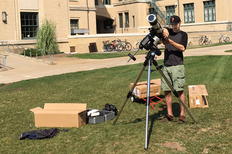 Image of Matt Walker setting up a telescope