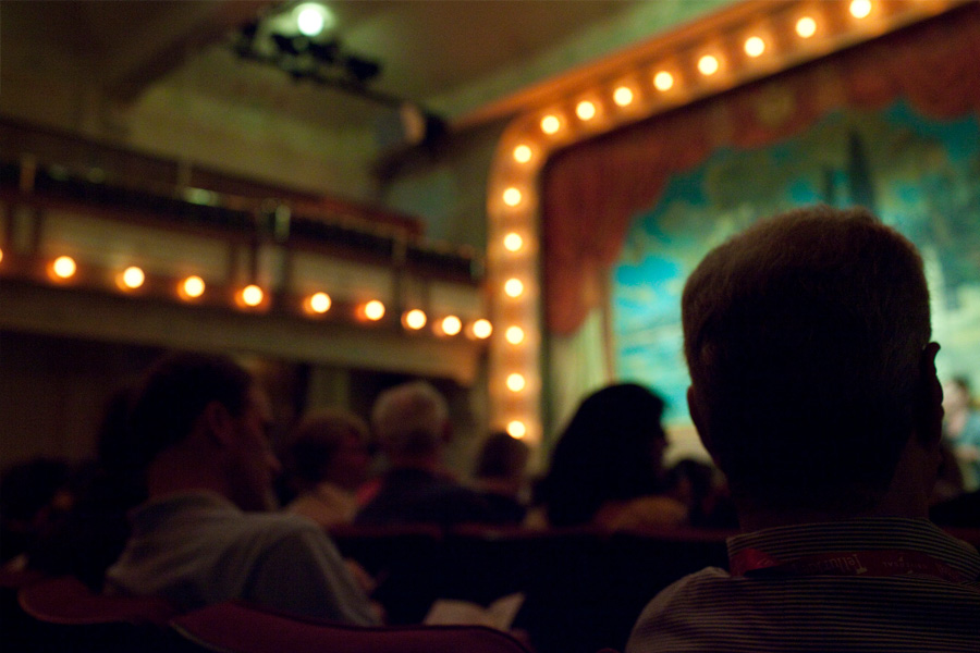 Image of the interior of an opera house that has been converted to watch movies