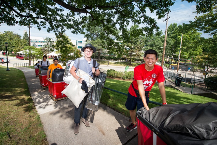 Image of students moving items into a dorm