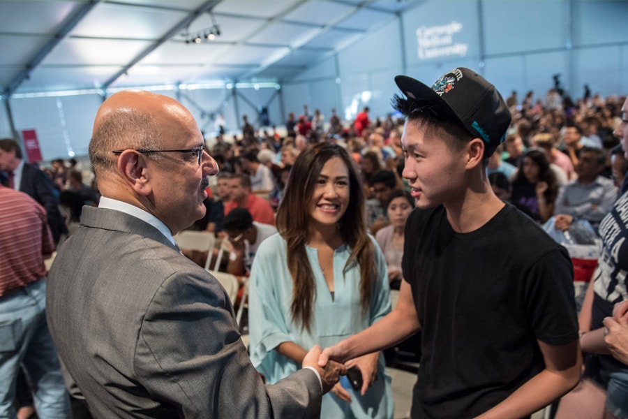 Image of CMU's president greeting a family