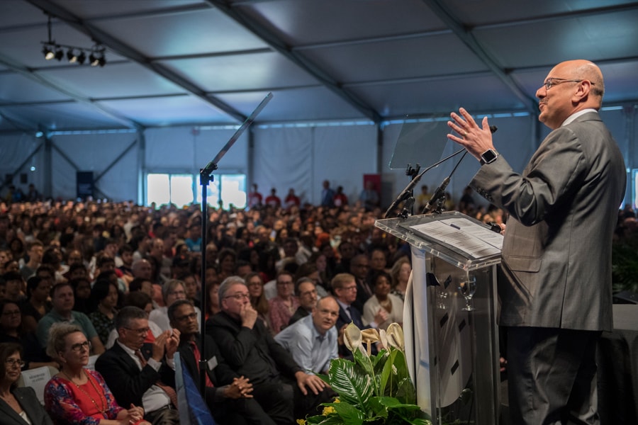 Image of CMU's president speaking to students and families