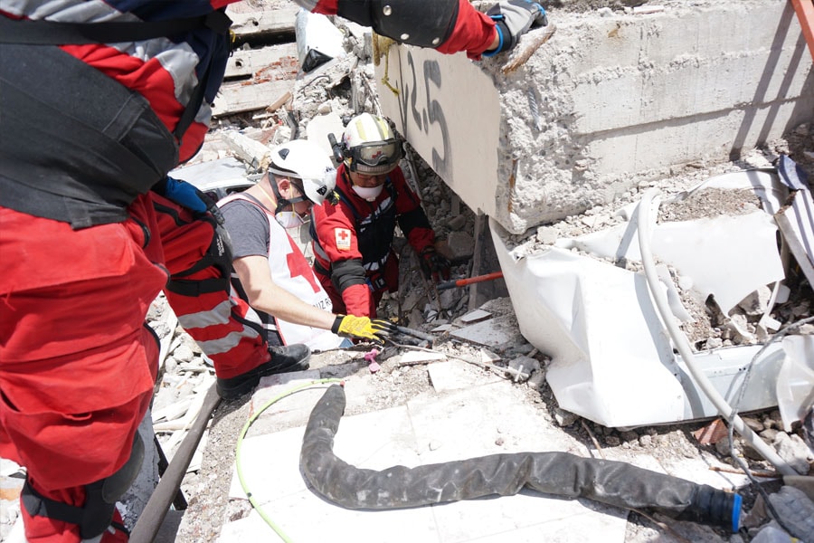 Image of rescuers in rubble