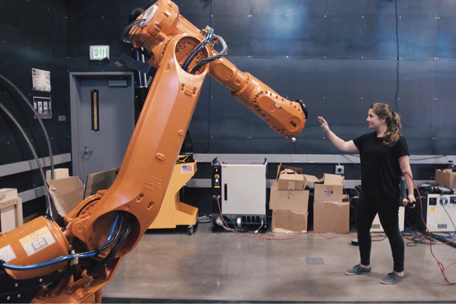 Madeline Gannon working with a robot