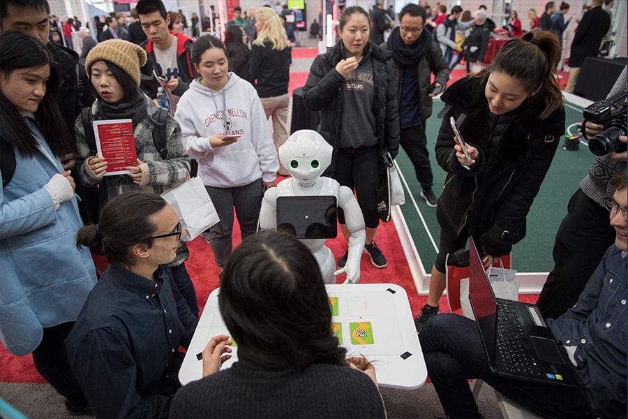 Image of students watching a robot