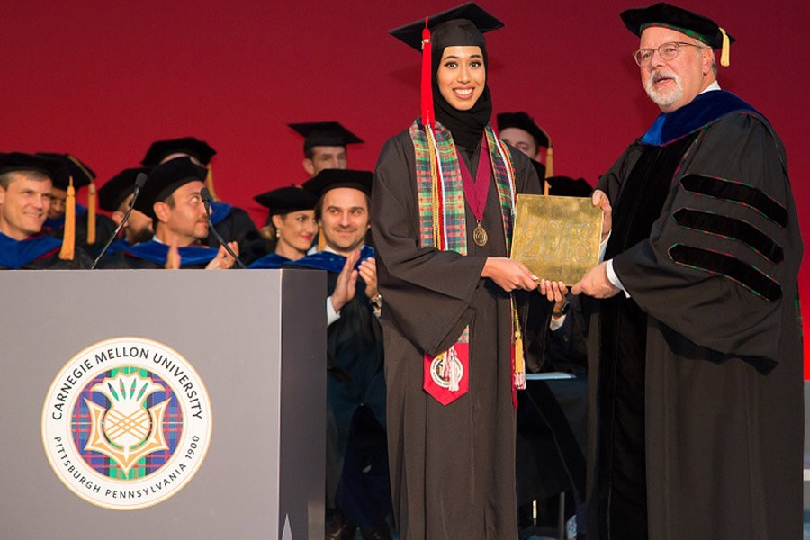 Image of student holding tile