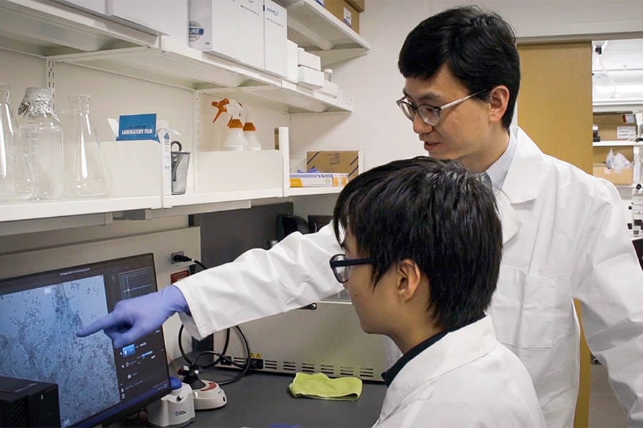 Image of Charlie Ren and a student