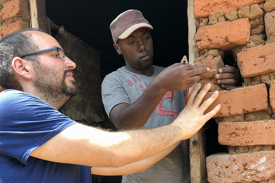 Image of Josh Schapiro installing a ventilation system 