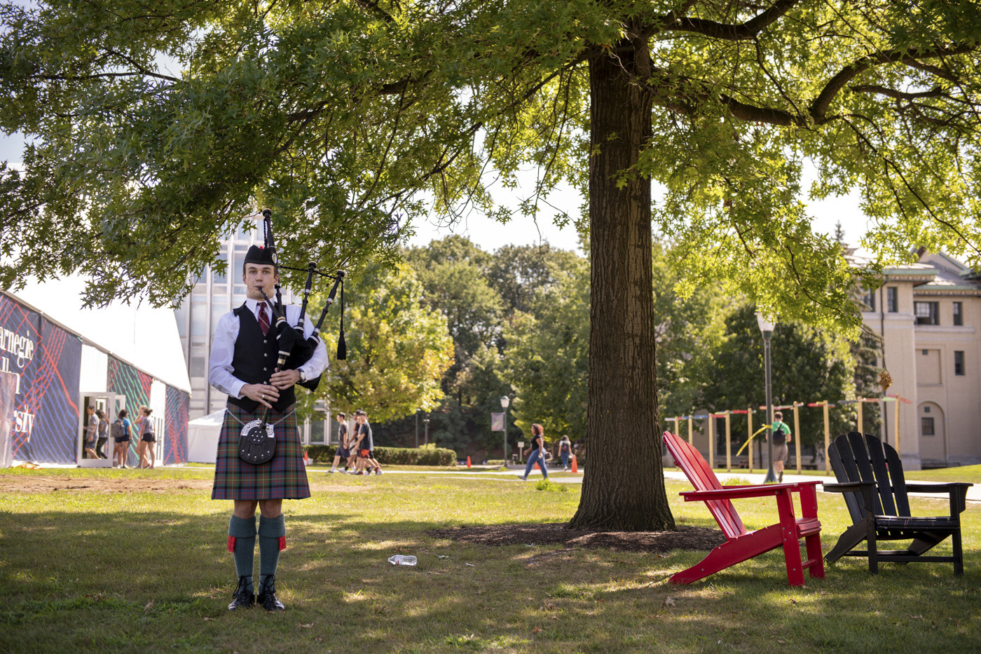 A bagpiper plays outside the Orientation tent.