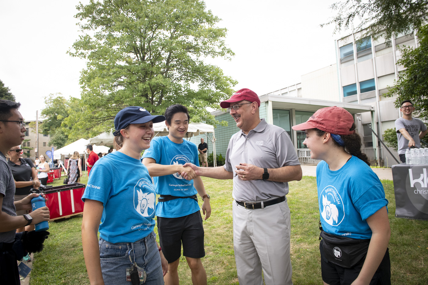 A photo of students shaking hands with Farnam Jahanian.