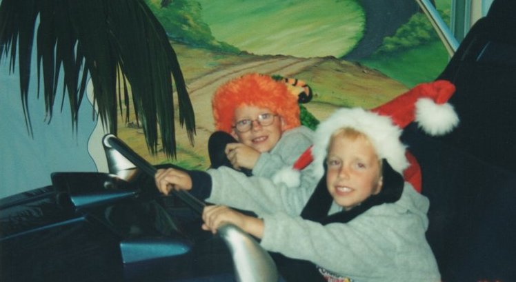 two young boys riding an amusement park ride