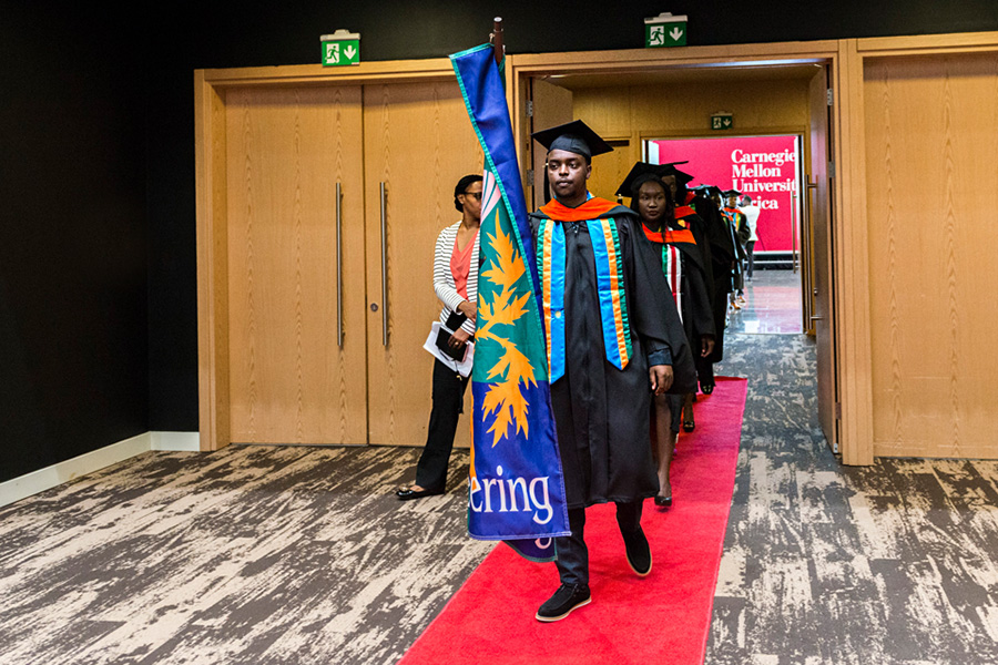 A photo of the graduates entering the room.