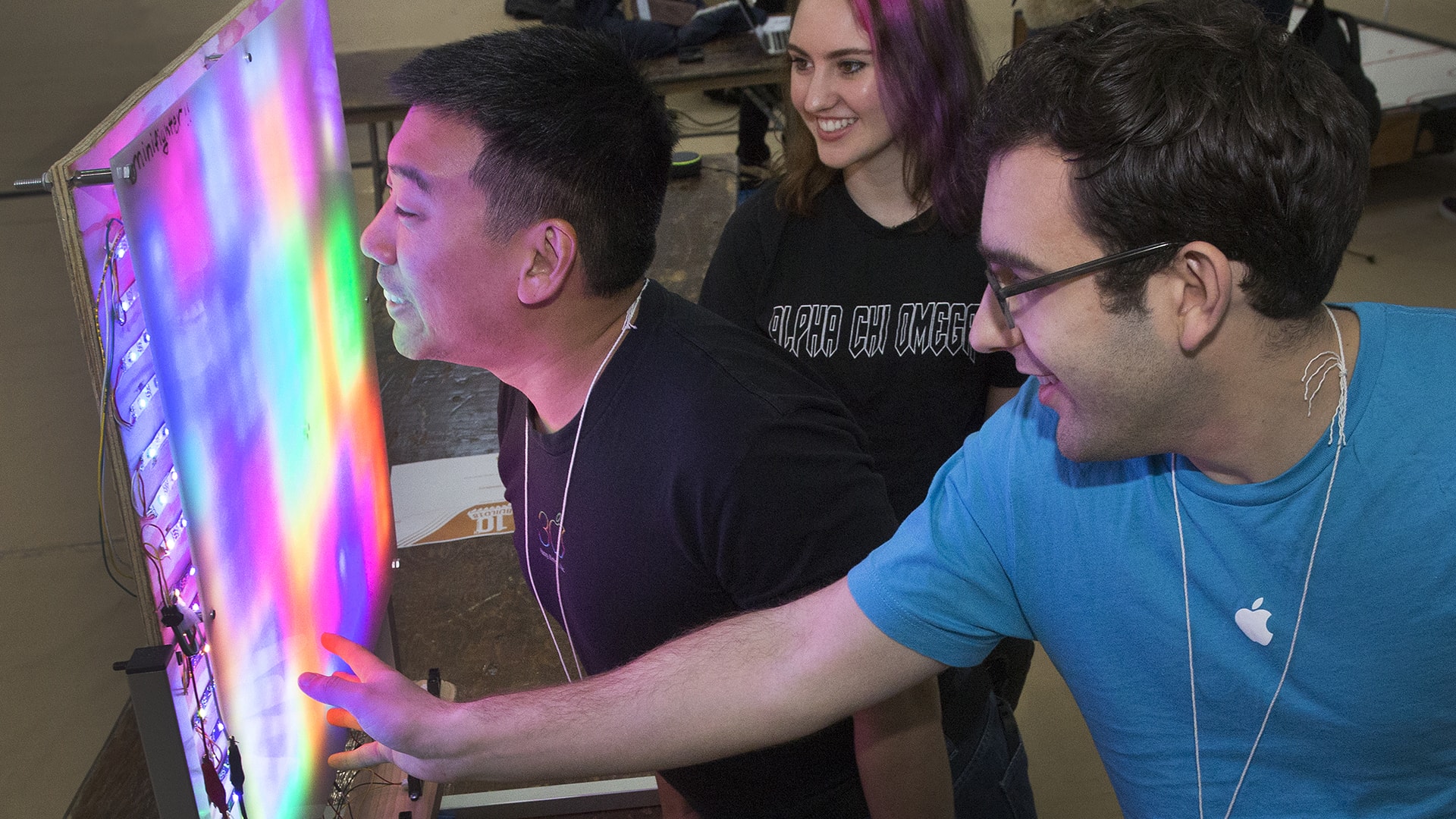 Image of people looking at a white board