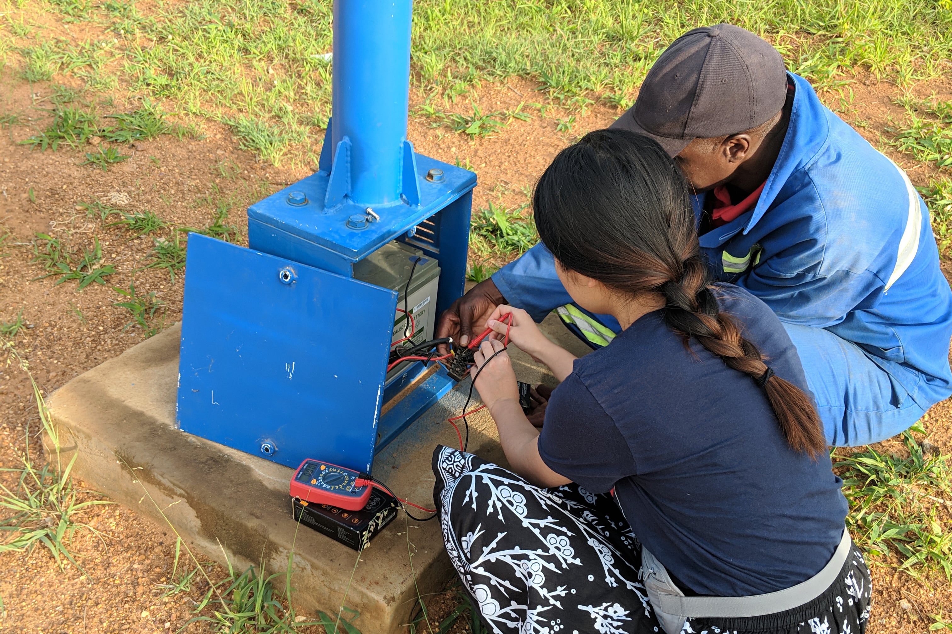 Image of people checking solar battery