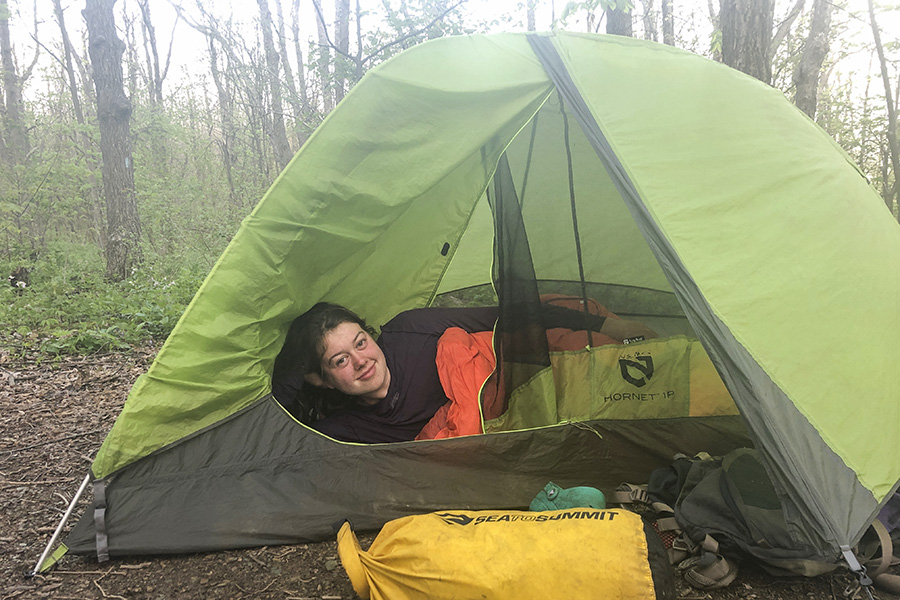 A photo of Eva Gerstle lying in a tent