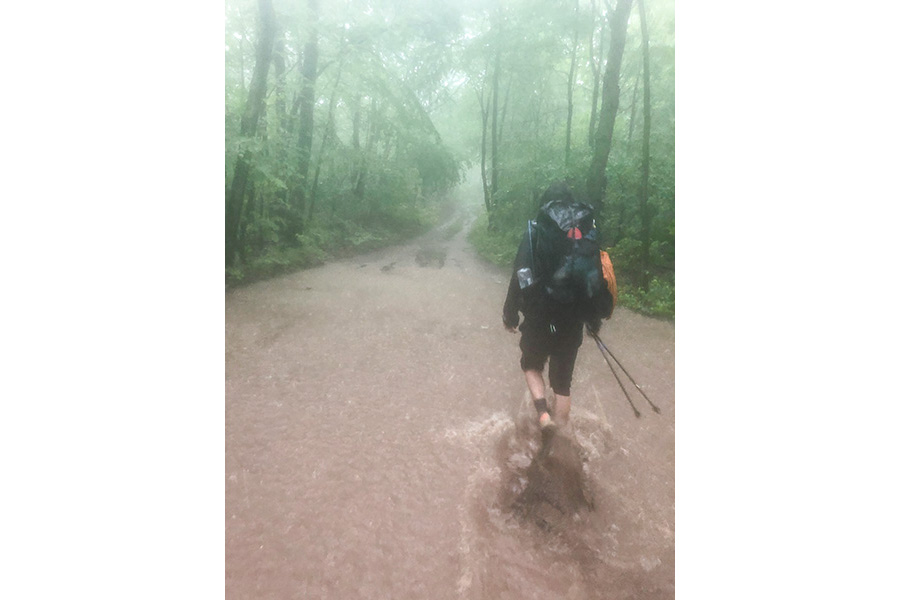 A hiker walks through heavy downpour on the Appalachian Trail