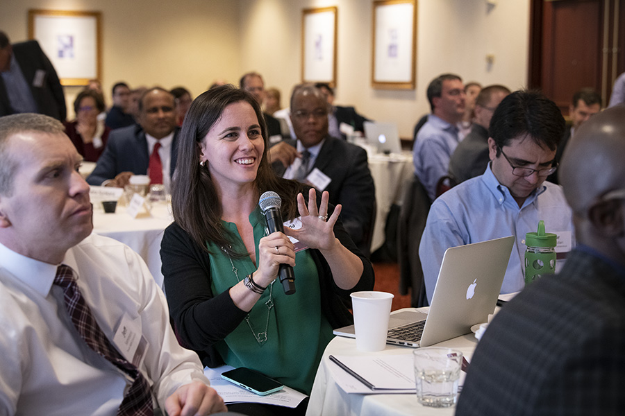 A photo of attendees asking questions