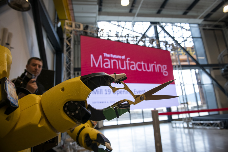 A photo of a demo robot holding a pair of scissors.