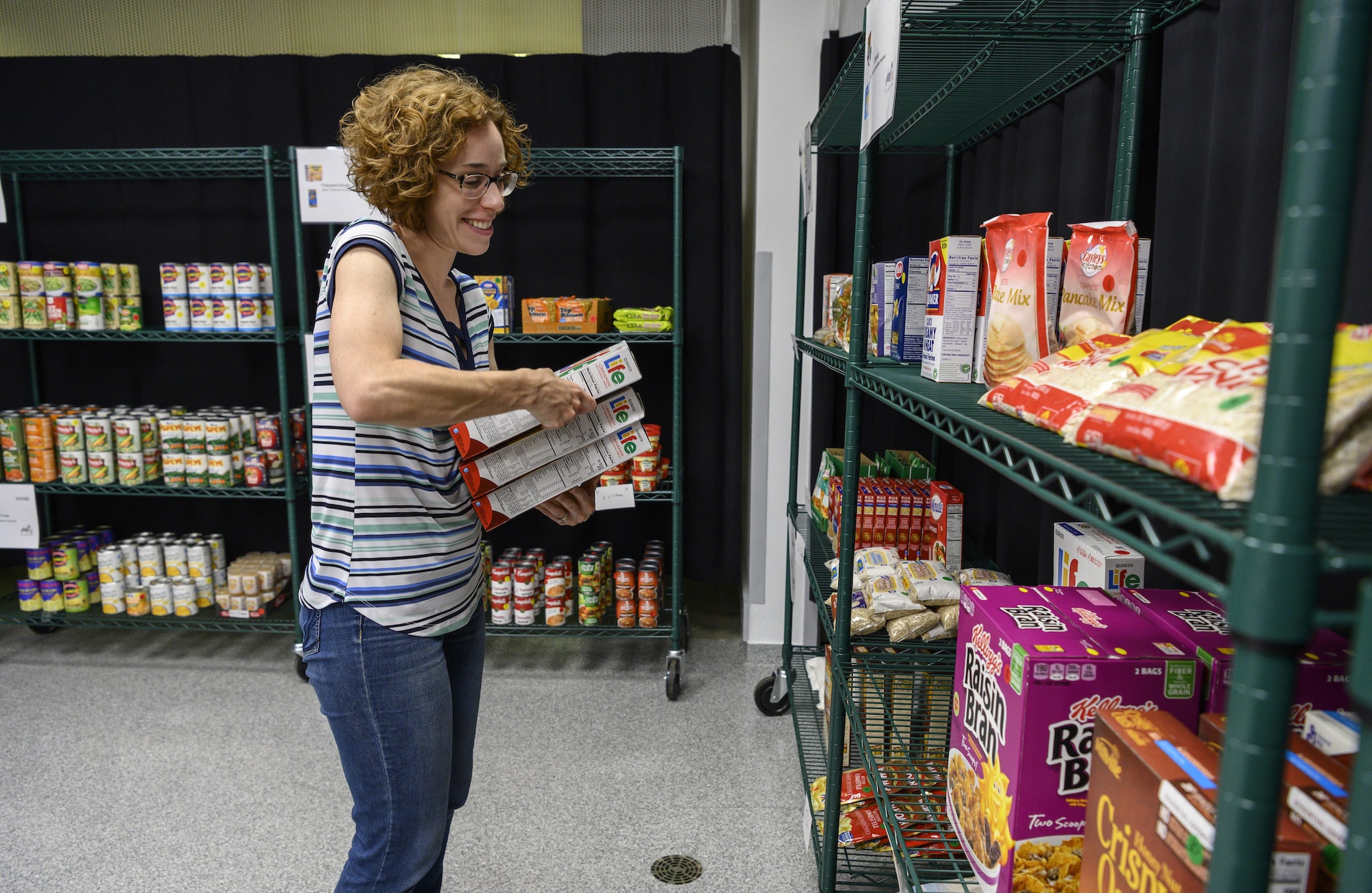 Liz Vaughan stocks shelves in the CMU pantry