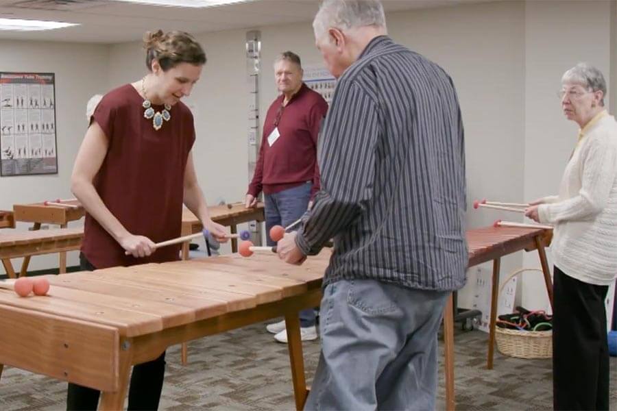 Image of Jennie Dorris helping student at marimba